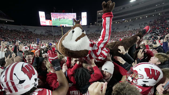 Bucky Badger crowds surfs after fans stormed the field. Bucky Badger crowds surfs after fans stormed the field.