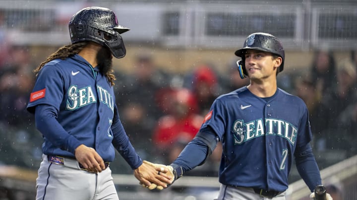 Apr 27, 2026; Minneapolis, Minnesota, USA; Seattle Mariners shortstop J.P. Crawford (3) celebrates with second baseman Cole Young (2) after scoring a run against the Minnesota Twins in the fifth inning at Target Field. Mandatory Credit: Jesse Johnson-Imagn Images