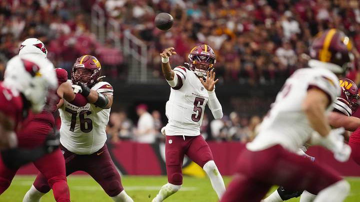 Commanders Jayden Daniels (5) throws for a first down against the Cardinals during a game at State Farm Stadium in Glendale on Sept. 29, 2024.
