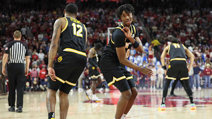 Missouri Tigers guards, Anthony Robinson II (0) and Tony Perkins (12), celebrate a bucket, in a game versus the Arkansas Razorbacks this season.