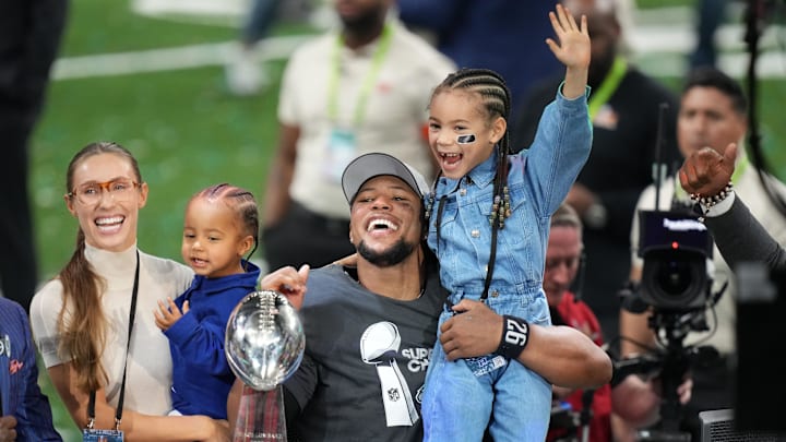 Feb 9, 2025; New Orleans, LA, USA; Philadelphia Eagles running back Saquon Barkley (26) talks to the media with his daughter, Jada, after defeating the Kansas City Chiefs in Super Bowl LIX at Caesars Superdome. 