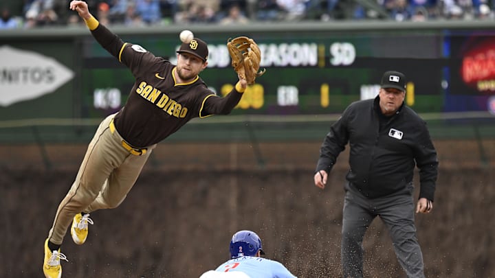 Apr 5, 2025; Chicago, Illinois, USA;  San Diego Padres second baseman Jake Cronenworth (9) can’t make the play as Chicago Cubs second baseman Nico Hoerner (2)  steals second base during the sixth inning at Wrigley Field. Mandatory Credit: Matt Marton-Imagn Images