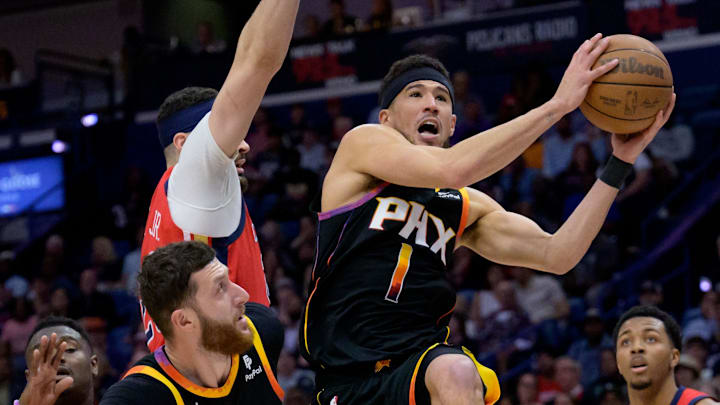 Apr 1, 2024; New Orleans, Louisiana, USA; Phoenix Suns guard Devin Booker (1) shoots against New Orleans Pelicans. 