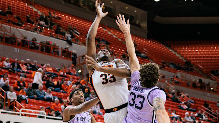 Jan 7, 2025; Stillwater, Oklahoma, USA; Oklahoma State Cowboys forward Abou Ousmane (33) shoots the ball over Kansas State Wildcats guard Coleman Hawkins (33) during the first half at Gallagher-Iba Arena. Mandatory Credit: William Purnell-Imagn Images