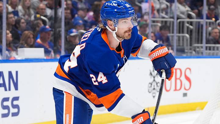 Apr 11, 2026; Elmont, New York, USA; New York Islanders defenseman Scott Mayfield (24) passes the puck in the first period at UBS Arena. Mandatory Credit: Alexander Wohl-Imagn Images