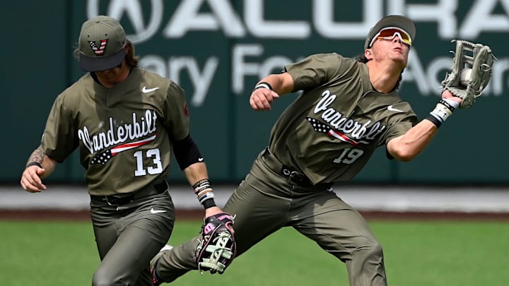 Vanderbilt left fielder catches a fly ball for an out hit by Georgia's Ryan Black Rustan Rigdon as Jonathan Vastine (13) moves out of the way during the third inning of an NCAA college baseball game at Hawkins Field Saturday, April 19, 2025, in Nashville, Tenn.