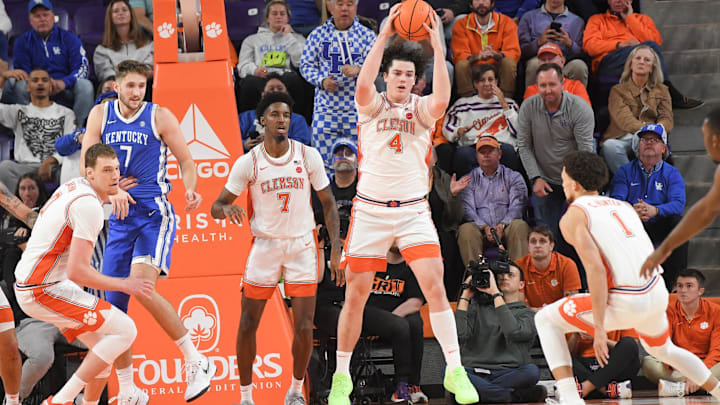 Dec 3, 2024; Clemson, South Carolina, USA; Clemson senior forward Ian Schieffelin (4) rebounds near Kentucky forward Andrew Carr (7) during the first half at Littlejohn Coliseum. Mandatory Credit: Ken Ruinard-Imagn Images