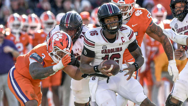 Nov 30, 2024; Clemson, South Carolina, USA; South Carolina quarterback LaNorris Sellers (16) runs away from Clemson defensive end T.J. Parker (3) during the fourth quarter at Memorial Stadium. Mandatory Credit: Ken Ruinard-Imagn Images Nov 30, 2024; Clemson, South Carolina, USA; South Carolina quarterback LaNorris Sellers (16) runs away from Clemson defensive end T.J. Parker (3) during the fourth quarter at Memorial Stadium. Mandatory Credit: Ken Ruinard-Imagn Images