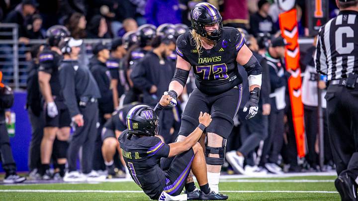 John Mills helps quarterback Demond Williams Jr. to his feet during the Minnesota game. John Mills helps quarterback Demond Williams Jr. to his feet during the Minnesota game.