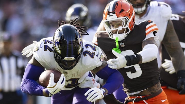 Baltimore Ravens running back Derrick Henry (22) runs the ball as Cleveland Browns safety Grant Delpit (9) tackles him during the fourth quarter at Huntington Bank Field. 