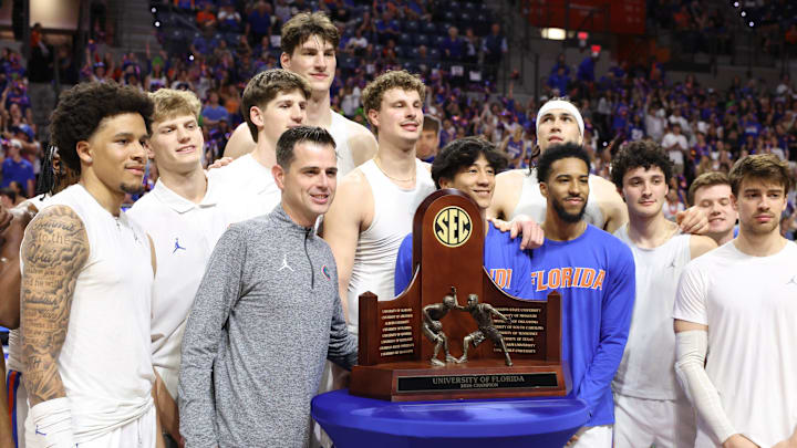 Florida head coach Todd Golden and the rest of the Florida basketball team pose with SEC championship trophy before the first half of an NCAA mens basketball game at Steven C. O'Connell Center Exactek arena in Gainesville, FL on Tuesday, March 3, 2026. [Alan Youngblood/Gainesville Sun]