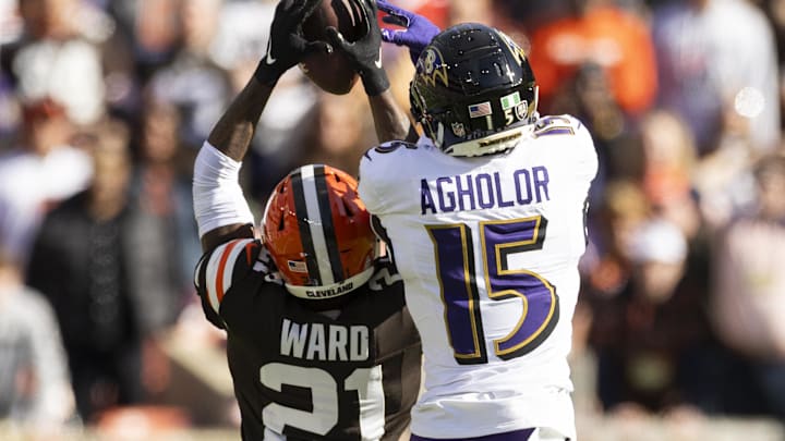 Oct 27, 2024; Cleveland, Ohio, USA; Cleveland Browns cornerback Denzel Ward (21) breaks up a pass intended for Baltimore Ravens wide receiver Nelson Agholor (15) during the second quarter at Huntington Bank Field. Mandatory Credit: Scott Galvin-Imagn Images