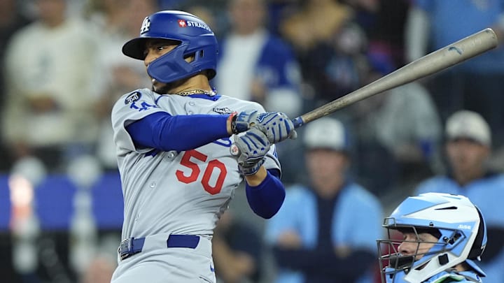 Oct 31, 2025; Toronto, Ontario, CAN; Los Angeles Dodgers shortstop Mookie Betts (50) hits a two RBI single against the Toronto Blue Jays in the third inning during game six of the 2025 MLB World Series at Rogers Centre. Mandatory Credit: John E. Sokolowski-Imagn Images Oct 31, 2025; Toronto, Ontario, CAN; Los Angeles Dodgers shortstop Mookie Betts (50) hits a two RBI single against the Toronto Blue Jays in the third inning during game six of the 2025 MLB World Series at Rogers Centre. Mandatory Credit: John E. Sokolowski-Imagn Images