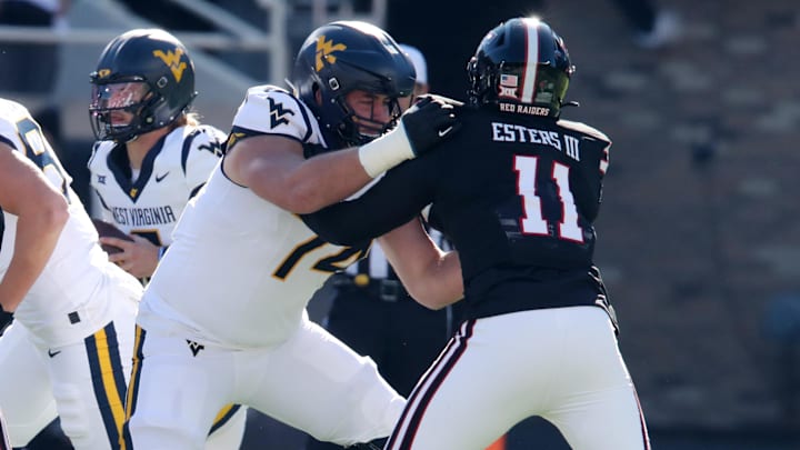 Nov 30, 2024; Lubbock, Texas, USA;  West Virginia Mountaineers offensive lineman Wyatt Milum (74) blocks Texas Tech Red Raiders defensive back Charles Esters III (11) in the first half at Jones AT&T Stadium and Cody Campbell Field. Mandatory Credit: Michael C. Johnson-Imagn Images