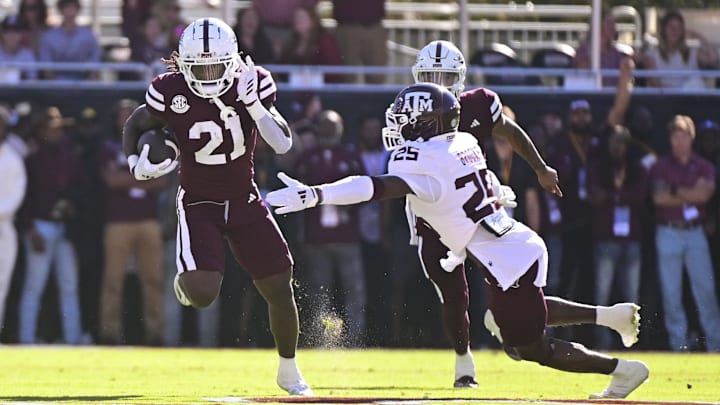 Oct 19, 2024; Starkville, Mississippi, USA; Mississippi State Bulldogs running back Davon Booth (21) runs the ball against Texas A&M Aggies defensive back Dalton Brooks (25) during the first quarter at Davis Wade Stadium at Scott Field. Mandatory Credit: Matt Bush-Imagn Images