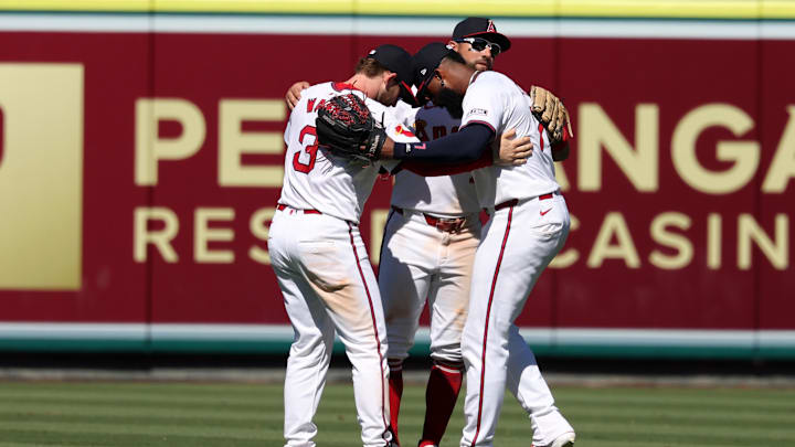 Jul 28, 2024; Anaheim, California, USA;  Los Angeles Angels left fielder Taylor Ward (3) and center fielder Kevin Pillar (12) and right fielder Jo Adell (7) celebrate a victory after defeating the Oakland Athletics 8-6 at Angel Stadium. Mandatory Credit: Kiyoshi Mio-Imagn Images