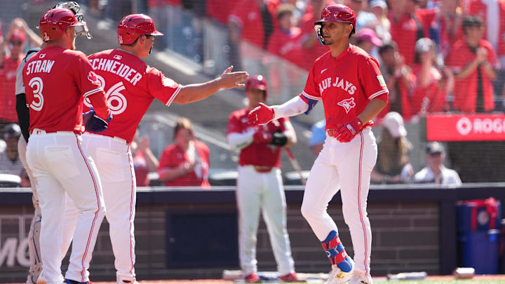 Jul 1, 2025: Toronto Blue Jays second baseman Andre Gimenez (0) hits a three run home run and celebrates with left fielder Davis Schneider (36) and centre fielder Myles Straw (3) against the New York Yankees during the fourth inning at Rogers Centre.
