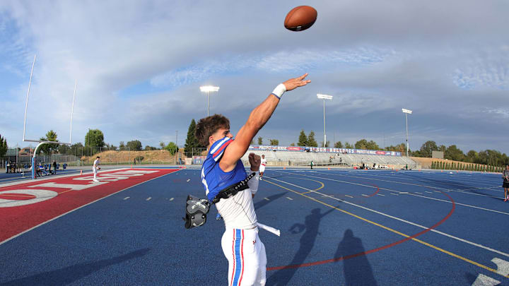 Folsom quarterback throws a pass during pregame warm ups. Folsom quarterback throws a pass during pregame warm ups.