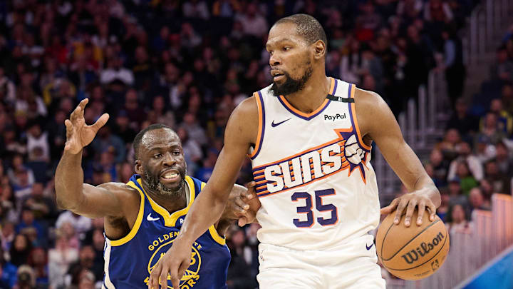 Dec 28, 2024; San Francisco, California, USA; Phoenix Suns forward Kevin Durant (35) controls the ball against Golden State Warriors forward Draymond Green (23) during the third quarter at Chase Center. Mandatory Credit: Robert Edwards-Imagn Images