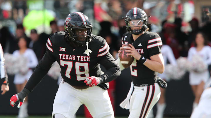 Nov 30, 2024; Lubbock, Texas, USA;  Texas Tech Red Raiders offensive guard Sterling Porcher (79) blocks for quarterback Behren Morton (2) in the second half during the game against the West Virginia Mountaineers at Jones AT&T Stadium and Cody Campbell Field. Mandatory Credit: Michael C. Johnson-Imagn Images
