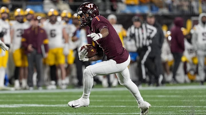 Jan 3, 2025; Charlotte, NC, USA; Virginia Tech Hokies cornerback Dante Lovett (1)  runs after his interception against the Minnesota Golden Gophers during the second half at the Duke’s Mayo Bowl at Bank of America Stadium. Mandatory Credit: Jim Dedmon-Imagn Images