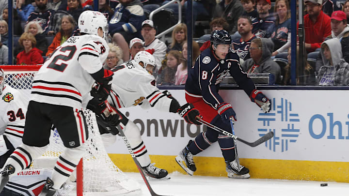 Nov 22, 2023; Columbus, Ohio, USA; Columbus Blue Jackets defenseman Zach Werenski (8) and Chicago Blackhawks defenseman Seth Jones (4) chase down a loose puck during the first period at Nationwide Arena. Mandatory Credit: Russell LaBounty-Imagn Images