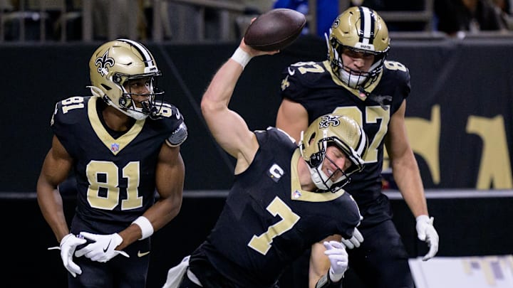 Nov 17, 2024; New Orleans, Louisiana, USA; New Orleans Saints tight end Taysom Hill (7) celebrates a touchdown with wide receiver Kevin Austin Jr. (81) and tight end Foster Moreau (87) in the first quarter against the Cleveland Browns at Caesars Superdome. Mandatory Credit: Matthew Hinton-Imagn Images