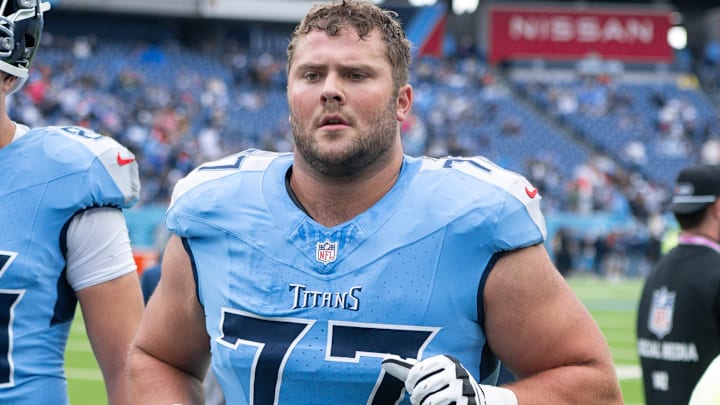 Oct 19, 2025; Nashville, Tennessee, USA;  Tennessee Titans offensive tackle Peter Skoronski (77) walks off the field against the New England Patriots during pre-game warmups at Nissan Stadium. Mandatory Credit: Steve Roberts-Imagn Images
