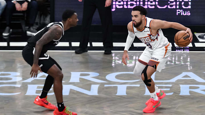 Jan 22, 2025; Brooklyn, New York, USA; Phoenix Suns guard Tyus Jones (21) sets the play while being defended by Brooklyn Nets forward Dariq Whitehead (0) during the first half at Barclays Center. Mandatory Credit: John Jones-Imagn Images