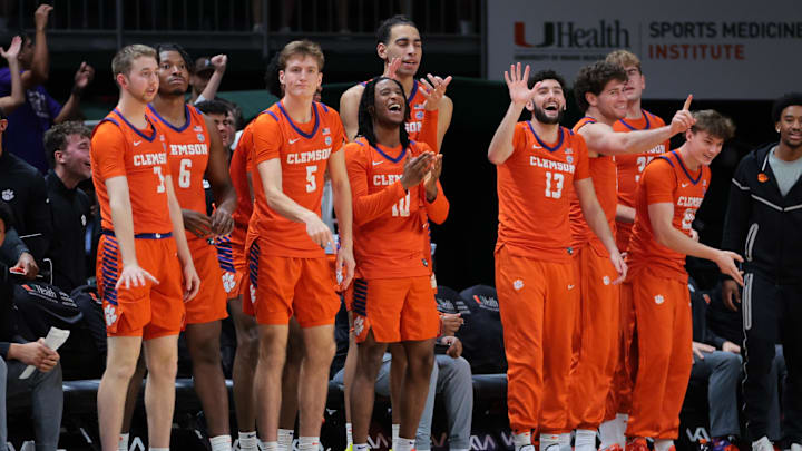 Dec 7, 2024; Coral Gables, Florida, USA; Clemson Tigers forward Asa Thomas (5), guard Del Jones (10) and guard Andrew Latiff (13) celebrate from the bench against the Miami Hurricanes during the second half at Watsco Center. Dec 7, 2024; Coral Gables, Florida, USA; Clemson Tigers forward Asa Thomas (5), guard Del Jones (10) and guard Andrew Latiff (13) celebrate from the bench against the Miami Hurricanes during the second half at Watsco Center.
