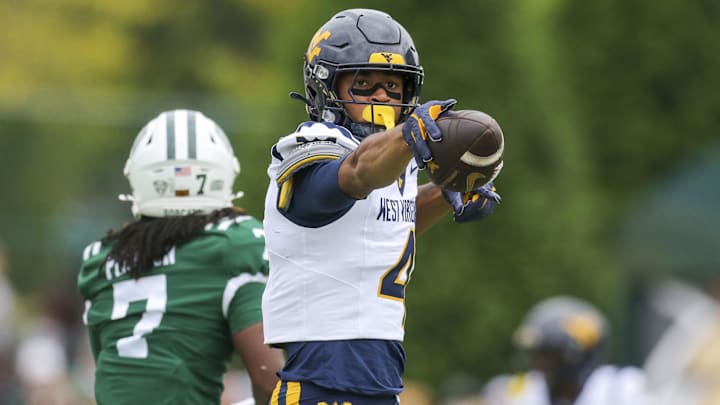 Sep 6, 2025; Athens, Ohio, USA; West Virginia Mountaineers wide receiver Cam Vaughn (4) celebrates a first down after a catch during the first quarter against the Ohio Bobcats at Peden Stadium. Mandatory Credit: Ben Queen-Imagn Images Sep 6, 2025; Athens, Ohio, USA; West Virginia Mountaineers wide receiver Cam Vaughn (4) celebrates a first down after a catch during the first quarter against the Ohio Bobcats at Peden Stadium. Mandatory Credit: Ben Queen-Imagn Images