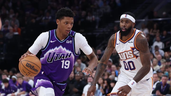 Oct 27, 2025; Salt Lake City, Utah, USA; Utah Jazz guard Ace Bailey (19) drives against Phoenix Suns forward Royce O'Neale (00) during the second half at Delta Center. Mandatory Credit: Rob Gray-Imagn Images Oct 27, 2025; Salt Lake City, Utah, USA; Utah Jazz guard Ace Bailey (19) drives against Phoenix Suns forward Royce O'Neale (00) during the second half at Delta Center. Mandatory Credit: Rob Gray-Imagn Images