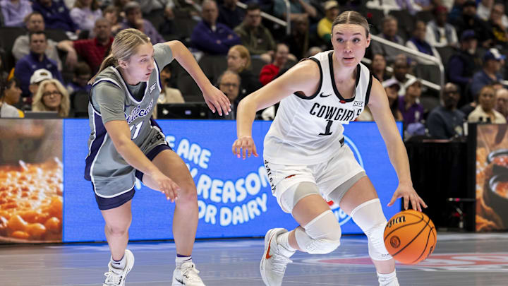 Mar 6, 2026; Kansas City, MO, USA;  Oklahoma State Cowgirls guard Amari Whiting (1) attempts to edge around Kansas State Wildcats guard Taryn Sides (11) during the first half at T-Mobile Center. Mandatory Credit: Nick Tre. Smith-Imagn Images