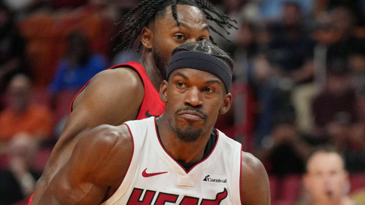 Apr 12, 2024; Miami, Florida, USA;  Miami Heat forward Jimmy Butler (22) drives past Toronto Raptors guard Immanuel Quickley (5) during the first half at Kaseya Center. Mandatory Credit: Jim Rassol-USA TODAY Sports