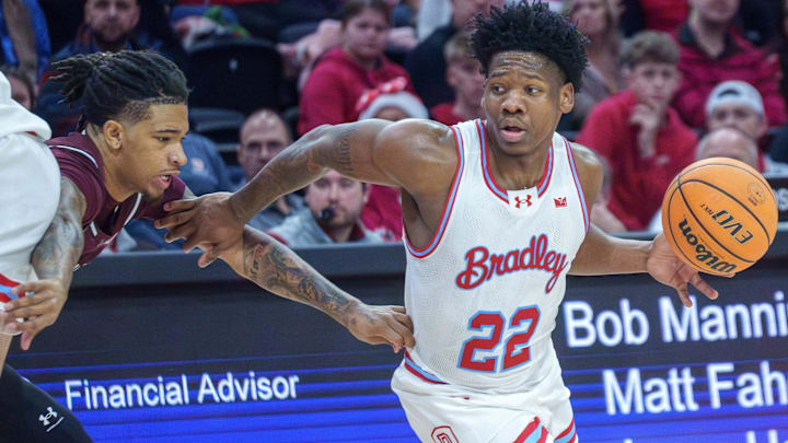 Bradley's Jaquan Johnson tries to outmaneuver SIU's Isaiah Stafford in the first half of their Missouri Valley Conference college basketball home opener Sunday, Dec. 21, 2025 at Carver Arena in Peoria. The Braves defeated the Salukis 73-69.
