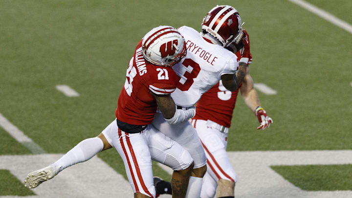 Dec 5, 2020; Madison, Wisconsin, USA;  Indiana Hoosiers wide receiver Ty Fryfogle (3) catches a pass between Wisconsin Badgers cornerback Caesar Williams (21) and safety Scott Nelson (9) during the third quarter at Camp Randall Stadium.