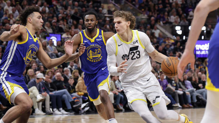 Feb 15, 2024; Salt Lake City, Utah, USA; Utah Jazz forward Lauri Markkanen (23) dribbles as Golden State Warriors forward Trayce Jackson-Davis (32) defends during the second quarter at Delta Center. Mandatory Credit: Chris Nicoll-USA TODAY Sports
