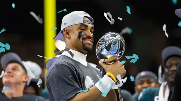 Feb 9, 2025; New Orleans, LA, USA; Philadelphia Eagles quarterback Jalen Hurts (1) celebrates with the Vince Lombardi Trophy after defeating the Kansas City Chiefs during Super Bowl LIX at Ceasars Superdome. Mandatory Credit: Mark J. Rebilas-Imagn Images