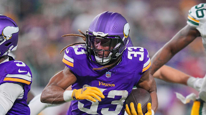 Dec 29, 2024; Minneapolis, Minnesota, USA; Minnesota Vikings running back Aaron Jones (33) runs with the ball against Green Bay Packers in the third quarter at U.S. Bank Stadium. Mandatory Credit: Brad Rempel-Imagn Images