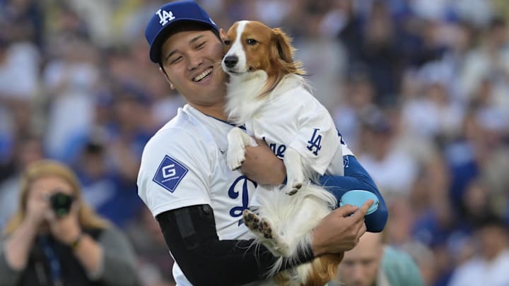 Los Angeles Dodgers designated hitter Shohei Ohtani (17) with his dog Decoy after he delivered he first pitch before the game against the Baltimore Orioles at Dodger Stadium. Los Angeles Dodgers designated hitter Shohei Ohtani (17) with his dog Decoy after he delivered he first pitch before the game against the Baltimore Orioles at Dodger Stadium.