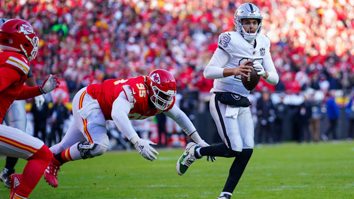 Nov 29, 2024; Kansas City, Missouri, USA; Las Vegas Raiders quarterback Aidan O'Connell (12) is sacked by Kansas City Chiefs defensive tackle Chris Jones (95) during the first half at GEHA Field at Arrowhead Stadium. Mandatory Credit: Denny Medley-Imagn Images