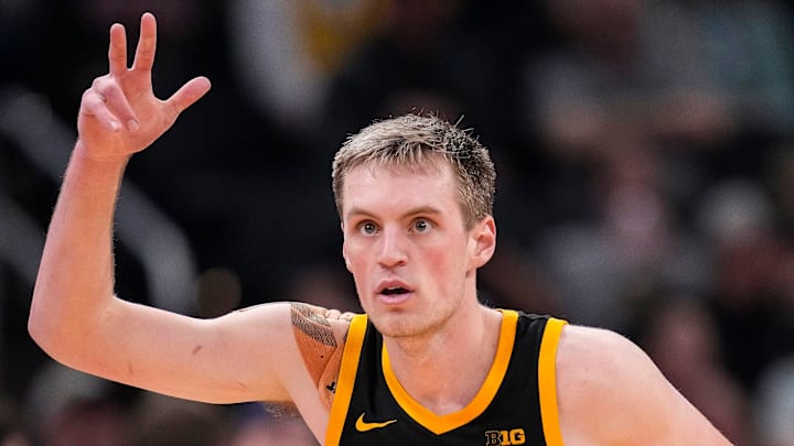 Iowa Hawkeyes forward Payton Sandfort (20) celebrate scoring a three-point basket Thursday, March 13, 2025, during the second round of the men's Big Ten tournament at Gainbridge Fieldhouse in Indianapolis. The Illinois Fighting Illini defeated the Iowa Hawkeyes, 106-94. Iowa Hawkeyes forward Payton Sandfort (20) celebrate scoring a three-point basket Thursday, March 13, 2025, during the second round of the men's Big Ten tournament at Gainbridge Fieldhouse in Indianapolis. The Illinois Fighting Illini defeated the Iowa Hawkeyes, 106-94.