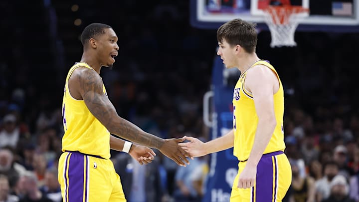 Mar 1, 2023; Oklahoma City, Oklahoma, USA; Los Angeles Lakers guard Lonnie Walker IV (4) and guard Austin Reaves (15) celebrate after scoring against the Oklahoma City Thunder during the second half at Paycom Center. Mandatory Credit: Alonzo Adams-Imagn Images