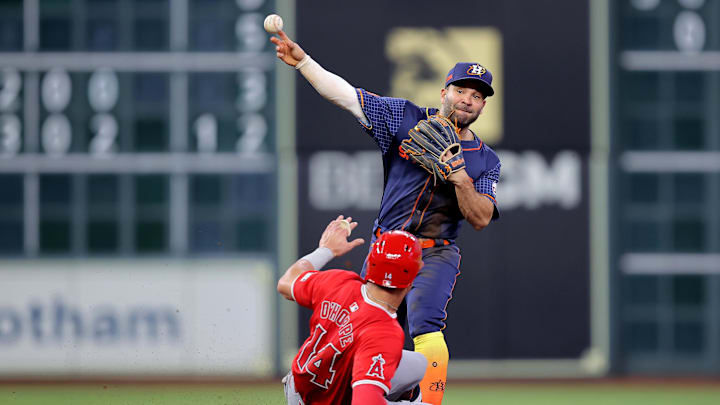 May 20, 2024; Houston, Texas, USA; Houston Astros second baseman Jose Altuve (27) throws a fielded ball to first base to complete a double play against the Los Angeles Angels during the fourth inning at Minute Maid Park. Mandatory Credit: Erik Williams-USA TODAY Sports