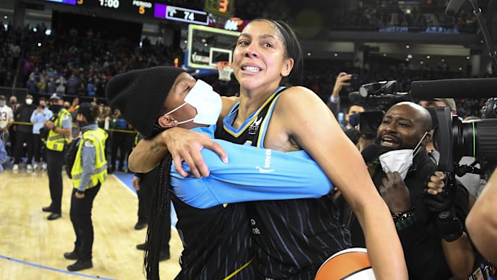 Oct 17, 2021; Chicago, Illinois, USA; Chicago Sky forward/center Candace Parker, center, is overcome with emotion as she is hugged by her daughter , Lailaa Nicole Williams, left, after the Sky won the WNBA Championship against the Phoenix Mercury at Wintrust Arena. Mandatory Credit: Matt Marton-Imagn Images