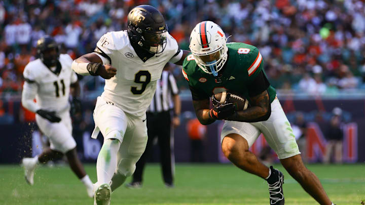 Nov 23, 2024; Miami Gardens, Florida, USA; Miami Hurricanes tight end Elijah Arroyo (8) runs with the football as Wake Forest Demon Deacons linebacker Quincy Bryant (9) attempts a tackle during the second quarter at Hard Rock Stadium. Mandatory Credit: Sam Navarro-Imagn Images Nov 23, 2024; Miami Gardens, Florida, USA; Miami Hurricanes tight end Elijah Arroyo (8) runs with the football as Wake Forest Demon Deacons linebacker Quincy Bryant (9) attempts a tackle during the second quarter at Hard Rock Stadium. Mandatory Credit: Sam Navarro-Imagn Images