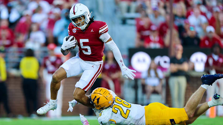 Oklahoma wide receiver Isaiah Sategna III (5) tries to avoid the tackle of Kent State safety Brodyn Bishop (28) during the second half Saturday at Gaylord Family — Oklahoma Memorial Stadium. Sategna turned it yet another big game in the victory.