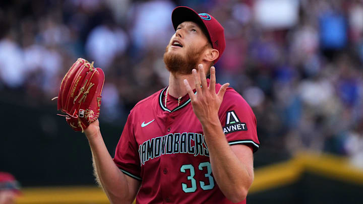 Arizona Diamondbacks left-hander A.J. Puk (33) reacts after closing out their 10-6 win against the Chicago Cubs at Chase Field in Phoenix on Sunday, March 30, 2025.