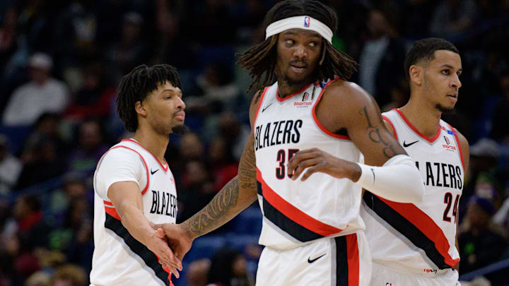 Jan 8, 2025; New Orleans, Louisiana, USA; Portland Trail Blazers guard Anfernee Simons (1) and center Robert Williams III (35) celebrate next to forward Kris Murray (24) during the first half against the New Orleans Pelicans at Smoothie King Center. Mandatory Credit: Matthew Hinton-Imagn Images