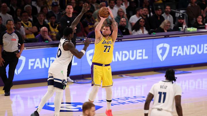 Los Angeles Lakers guard Luka Doncic shoots the ball over Minnesota Timberwolves forward Julius Randle during the third quarter of Game 2 of their first-round playoff series at Crypto.com Arena in Los Angeles on April 22, 2025.